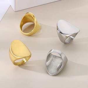 Detail of minimalist asymmetric oval rings in gold and silver with polished and brushed finish