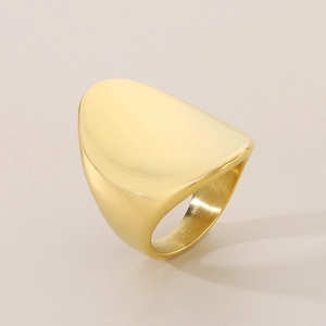 Detail view of the polished gold irregular curved surface and lustrous metal texture