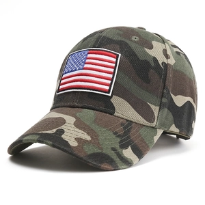Detail of USA flag embroidery on a jungle camouflage baseball cap with twill texture