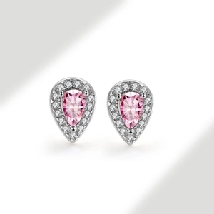 Macro shot of silver teardrop stud earrings with pink gemstone and halo zircon settings