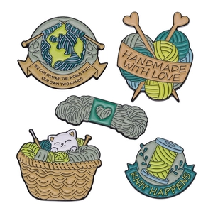 Set of 5 enamel pins featuring creative knitting themes and cat in a yarn basket