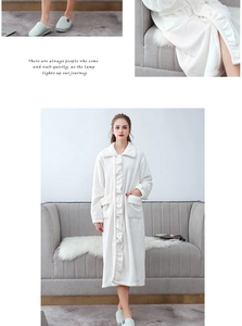 Detail of white flannel bathrobe with ruffle trim and soft fleece texture in home setting