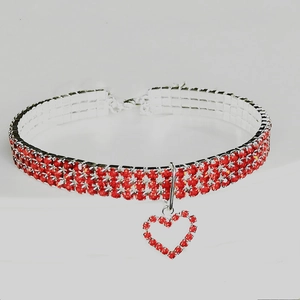 Detailed view of red rhinestone pet collar with heart pendant and adjustable silver chain