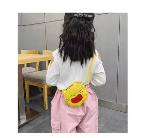 Detail view of a yellow cartoon cat crossbody bag for girls made of durable PU leather