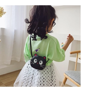Rear view of a child wearing a black cartoon cat-shaped crossbody bag with ear details