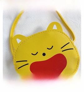 Close-up of yellow cartoon cat mini crossbody bag with cute facial print and zipper