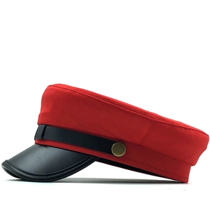 Classic red British style flat top cap with black leather brim and golden button accents