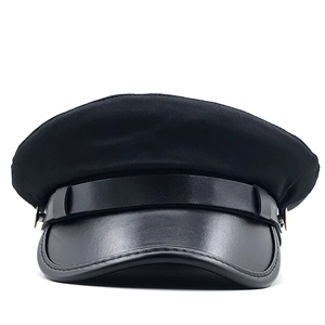 Detailed view of black fiddler cap showing fabric texture and gold button detail