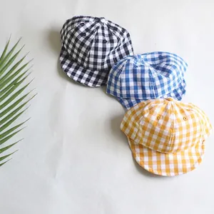 Three infant plaid cotton baseball caps in black, blue, and yellow with soft brims