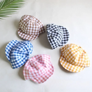 Flat lay of cotton gingham baby hats in five colors including pink blue and yellow