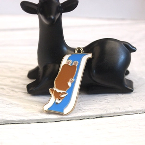 Detail of creative enamel alloy pendant featuring a corgi dog sliding on a blue slide