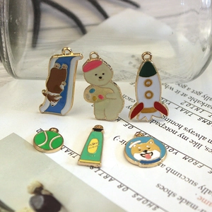 Macro detail of cartoon enamel alloy pendants with dog and polar bear motifs for jewelry DIY