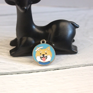 Detail of Shiba Inu astronaut enamel pendant on a black decorative stand