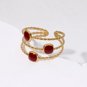 Three-layer gold-plated stainless steel ring with red enamel square accents