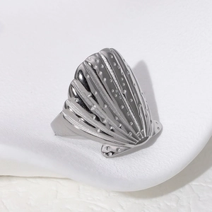Polished silver shell shaped stainless steel open ring on a neutral display stand