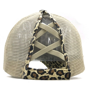 Detail of leopard print trim and crisscross elastic ponytail hole on mesh trucker cap
