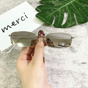 Close-up of retro silver rectangular metal sunglasses with gradient tinted lenses
