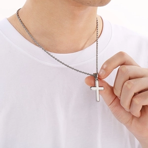 Men's silver stainless steel cross pendant necklace with twisted rope chain on model
