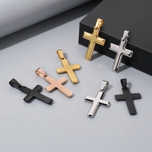 Multiple cross pendants in gold, silver, and black finishes with matte and glossy textures