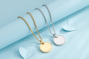 Detailed close-up of gold and silver round pendants with diamond-set edges on rope chains