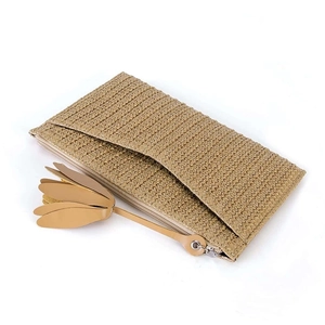 Women's straw woven clutch bag with leather flower zipper pull and brown handle details