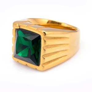 Macro shot of gold men's ring with a faceted square green gemstone and striped texture