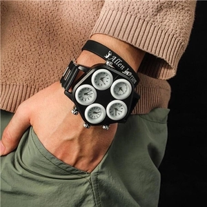 Detailed close-up of a five-timezone men's watch with white dials and black silicone strap