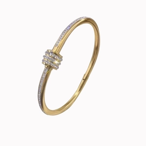 Gold stainless steel bangle with a triple-layered pavé-set knot design and clear stones