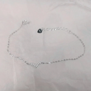 Macro detail of S925 sterling silver bracelet with V-shaped zircon pendant and extension chain