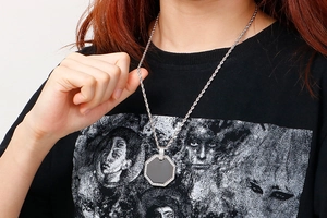 Octagonal titanium steel pendant with black center and crystals shown on model