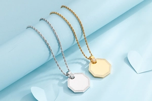 Detail of gold and silver octagonal pendants with inset crystals and twisted rope chains