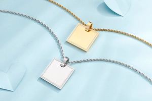Detail view of square gold and silver pendants with pavé zircons and twist chains