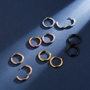 Titanium steel hoop earrings set for men and women in five metallic finishes on blue background