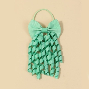 Detail of mint green grosgrain ribbon hair tie with corkscrew tassels for girls