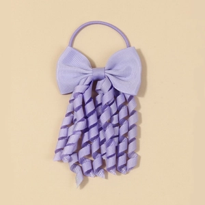 Detail of lavender grosgrain ribbon bow hair tie with cute curly spiral streamers