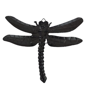 Detail view of black metal dragonfly wall decor with textured wings and hanging loop
