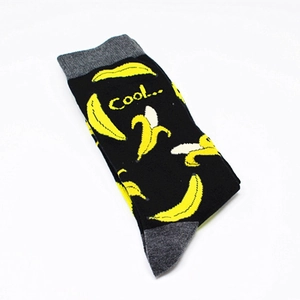 Detail of cotton crew socks featuring yellow banana patterns and a cool text design