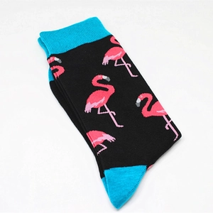 Detailed macro view of black cotton crew socks featuring pink flamingo patterns and blue heels
