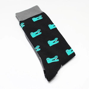 Detail of mid-calf cotton socks in black featuring green cartoon crocodile patterns