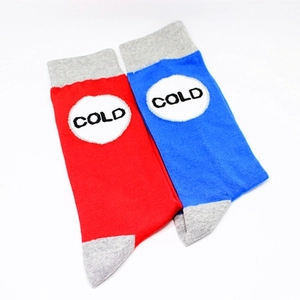 Detailed knit texture of red and blue cotton socks featuring COLD lettering