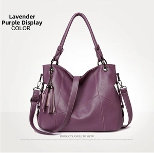 Detail view of taro purple leather handbag featuring荔枝 grain texture and tassel charm