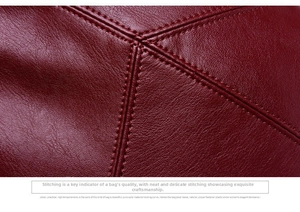 Macro shot of precise stitching and litchi texture on a large soft leather handbag