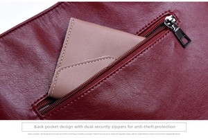 Close-up of wine red lychee leather bag featuring a functional rear zipper pocket