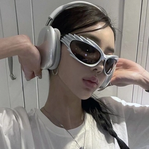 Silver Y2K futuristic sunglasses with shield frame and dark lenses shown on model