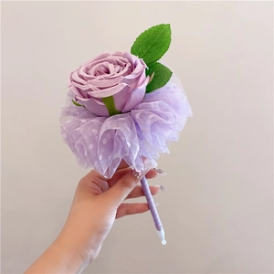 Detail of purple artificial rose pen with polka dot lace mesh and satin ribbon wrap