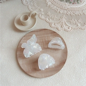 Three-piece iridescent acetate hair claw clips in butterfly and crescent shapes