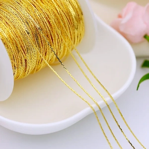 Macro shot of 18K gold plated copper chain on spool for DIY jewelry making