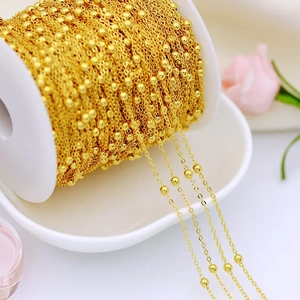 Detail of 18K gold-plated brass bead chain wrapped on a spool for DIY jewelry making