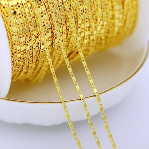 Macro shot of 18K gold plated copper flat faceted chain with shiny reflective links