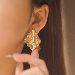 18K gold-plated irregular geometric stud earrings with molten lava texture on ear